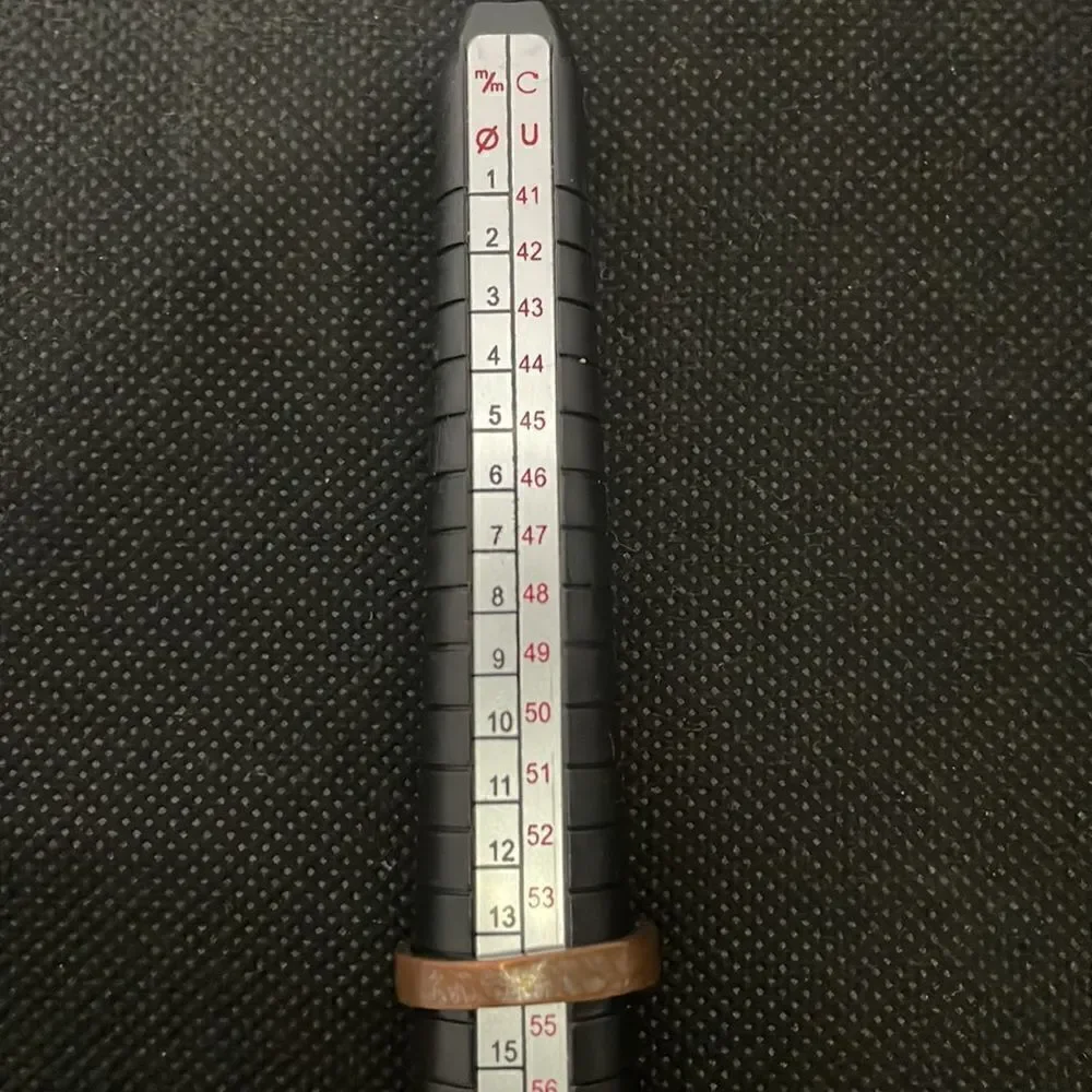 Metal ring with a row of white gems